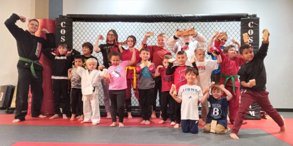 A student at Cosens Martial Arts in Oxford celebrates earning a new stripe in our Little Ninjas program.