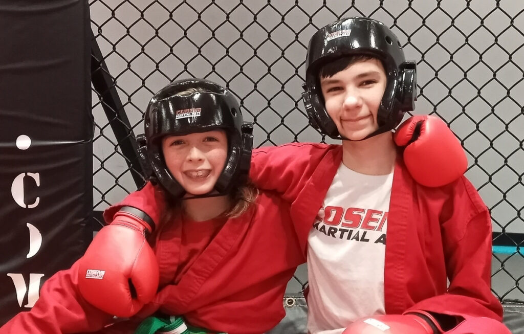 Two children doing a martial arts drill together in Oxford