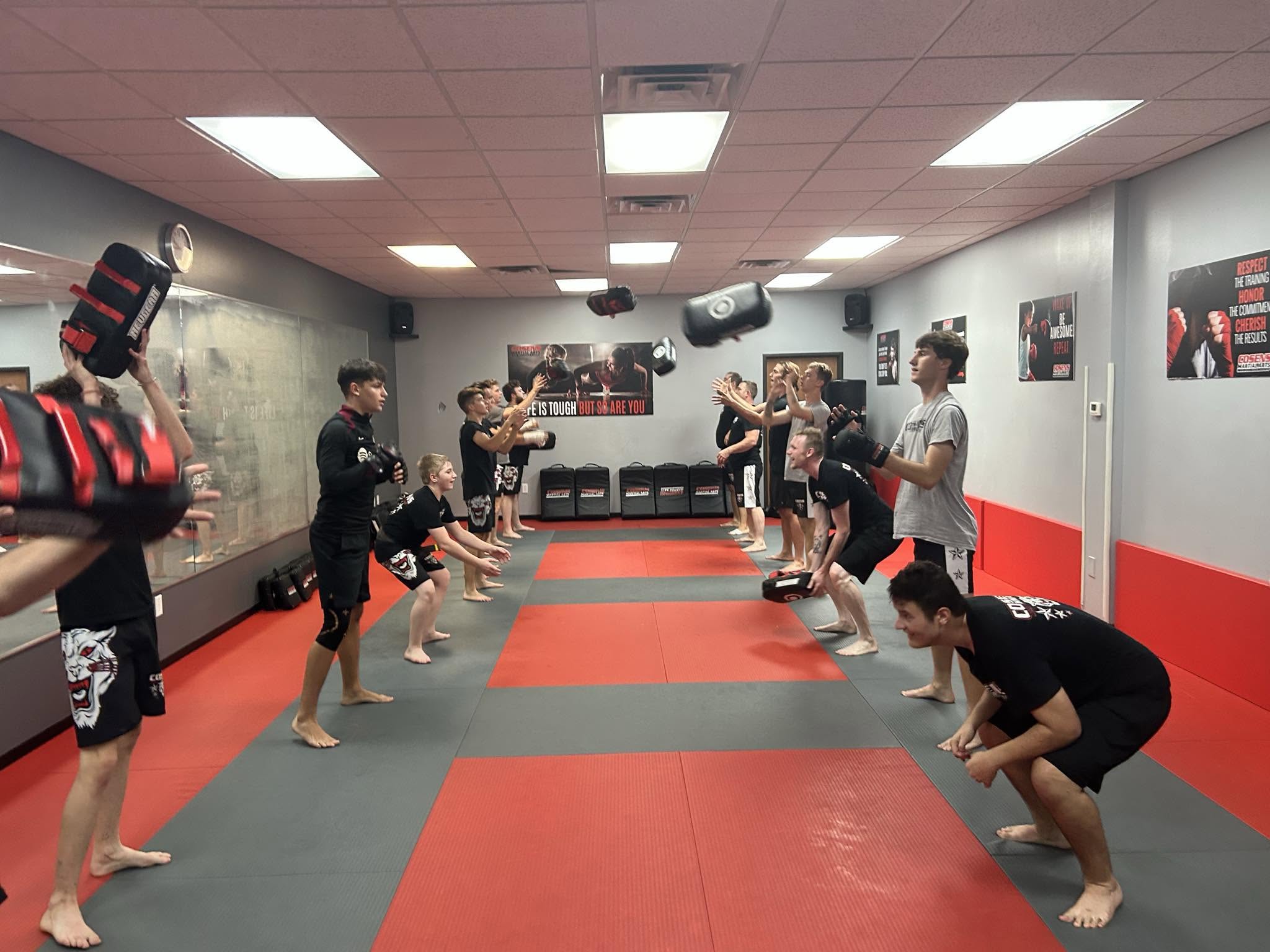 Adult MMA students having fun during an energetic training drill
